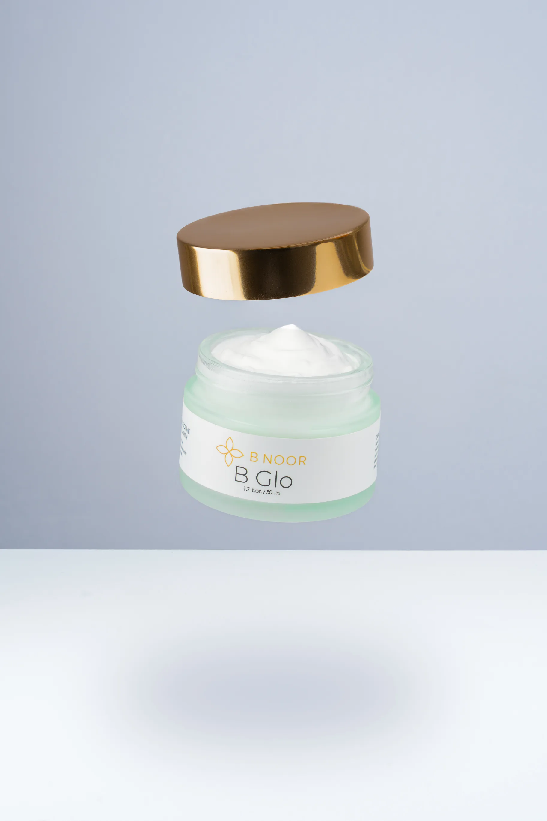B NOOR B Glo jar floating in air with lid opening