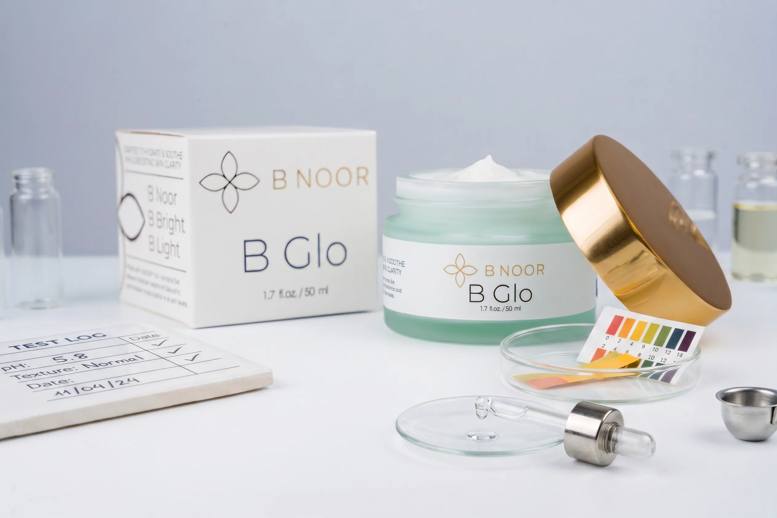 B NOOR B Glo jar in foreground with box behind, editorial hero shot